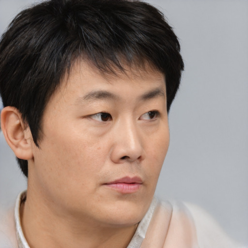 Neutral asian young-adult male with short  brown hair and brown eyes