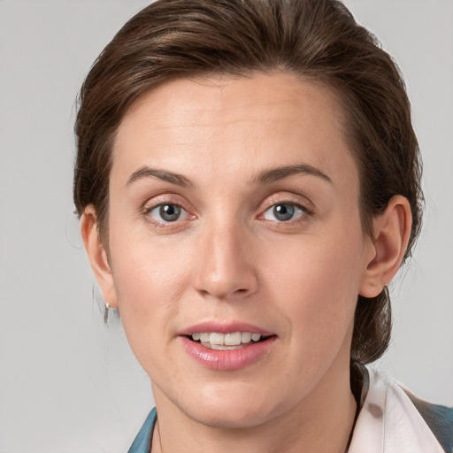 Joyful white young-adult female with medium  brown hair and grey eyes