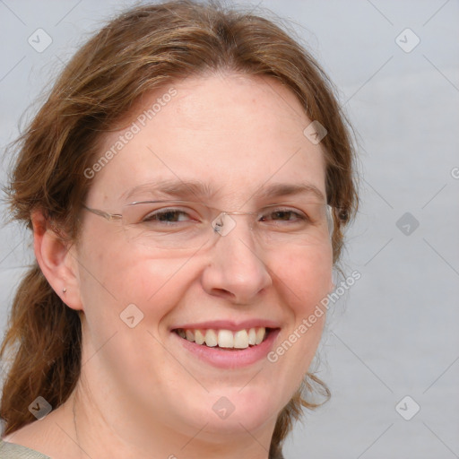 Joyful white adult female with medium  brown hair and blue eyes