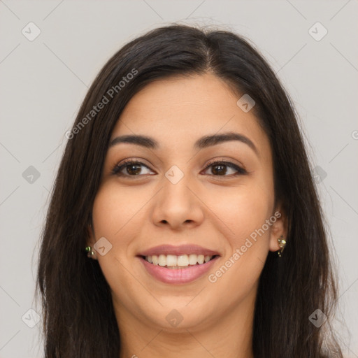 Joyful latino young-adult female with long  brown hair and brown eyes