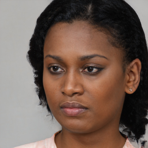 Neutral black young-adult female with medium  black hair and brown eyes