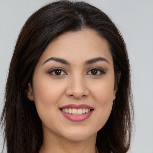 Joyful white young-adult female with long  brown hair and brown eyes