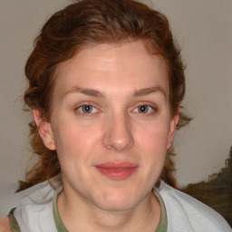 Joyful white adult female with medium  brown hair and blue eyes