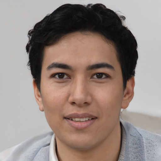 Joyful asian young-adult male with short  black hair and brown eyes