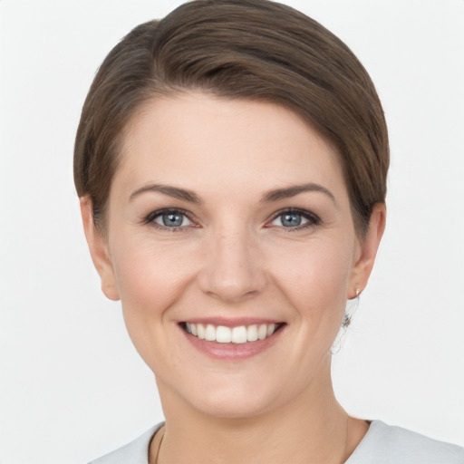 Joyful white young-adult female with short  brown hair and grey eyes