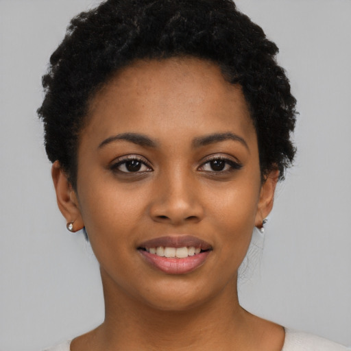 Joyful latino young-adult female with short  black hair and brown eyes