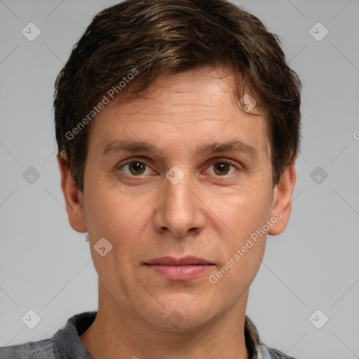 Joyful white adult male with short  brown hair and grey eyes