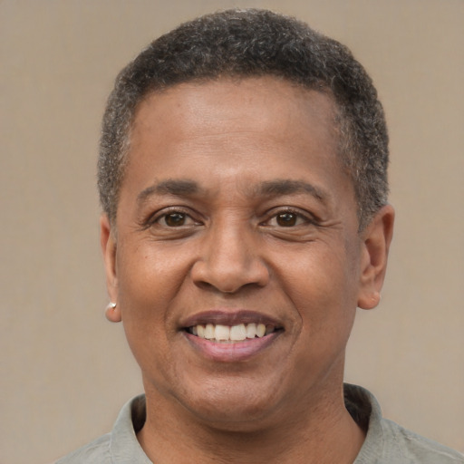 Joyful black adult male with short  brown hair and brown eyes