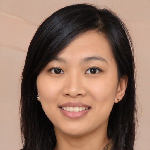 Joyful asian young-adult female with long  brown hair and brown eyes