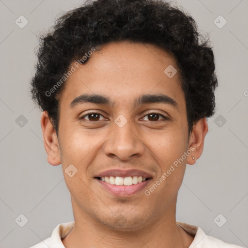 Joyful latino young-adult male with short  brown hair and brown eyes