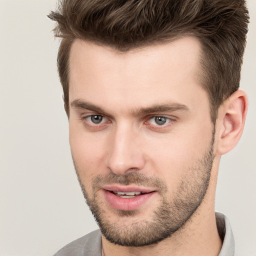 Joyful white young-adult male with short  brown hair and brown eyes