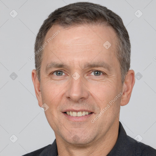 Joyful white adult male with short  brown hair and brown eyes