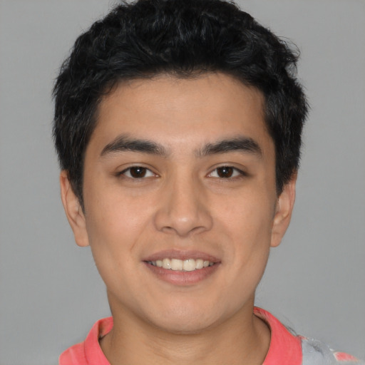 Joyful latino young-adult male with short  brown hair and brown eyes