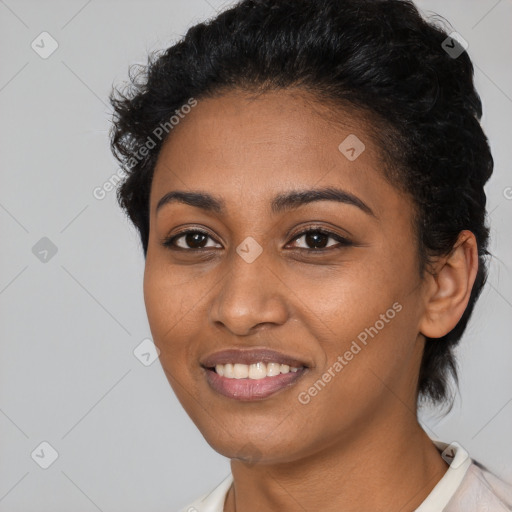 Joyful black young-adult female with short  black hair and brown eyes