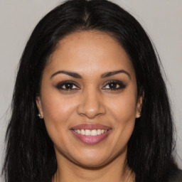 Joyful latino young-adult female with long  brown hair and brown eyes