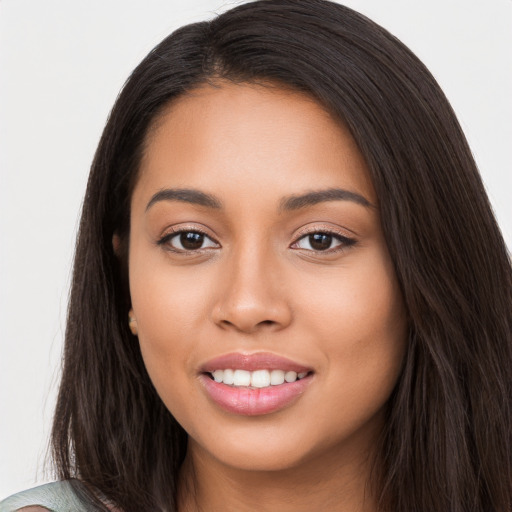 Joyful latino young-adult female with long  brown hair and brown eyes