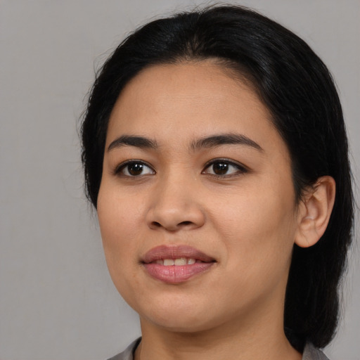 Joyful black young-adult female with medium  black hair and brown eyes