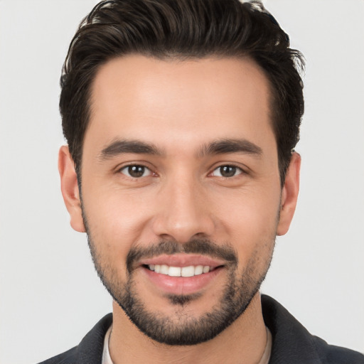 Joyful white young-adult male with short  black hair and brown eyes