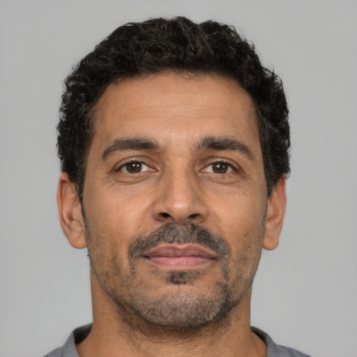 Neutral latino adult male with short  brown hair and brown eyes