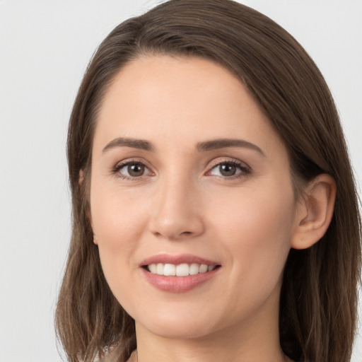 Joyful white young-adult female with long  brown hair and grey eyes