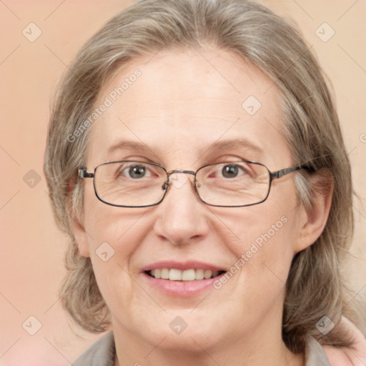 Joyful white adult female with medium  brown hair and blue eyes