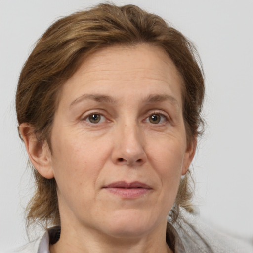 Joyful white adult female with medium  brown hair and grey eyes