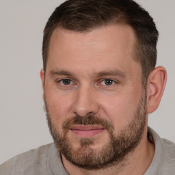 Joyful white adult male with short  brown hair and brown eyes