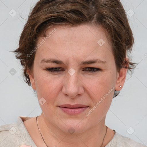 Joyful white adult female with short  brown hair and blue eyes