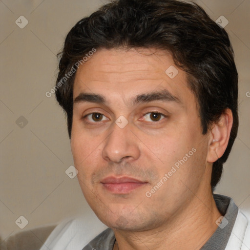 Joyful white adult male with short  black hair and brown eyes