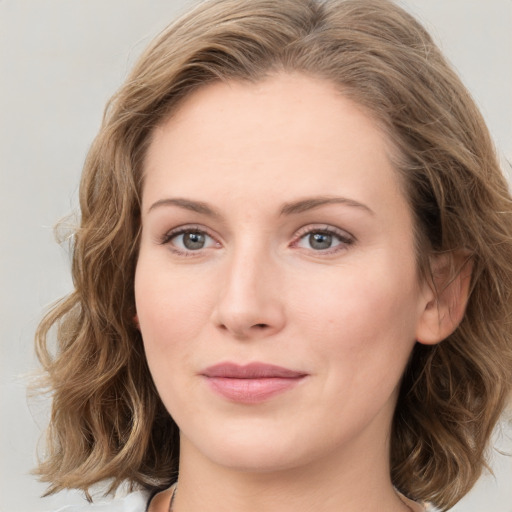 Joyful white young-adult female with medium  brown hair and blue eyes