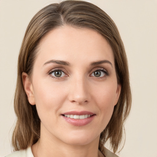 Joyful white young-adult female with medium  brown hair and green eyes