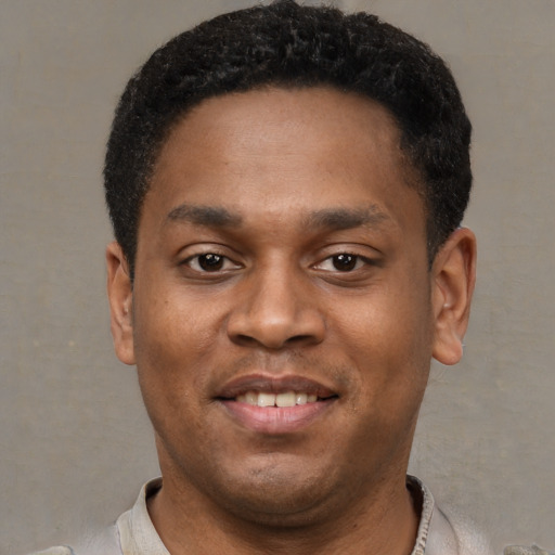 Joyful latino young-adult male with short  brown hair and brown eyes