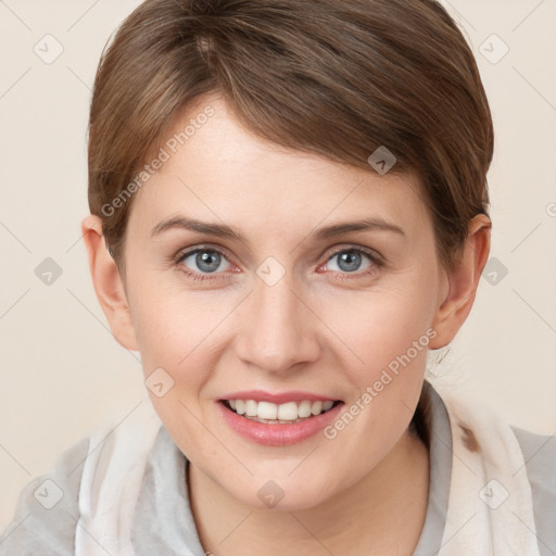 Joyful white young-adult female with short  brown hair and grey eyes