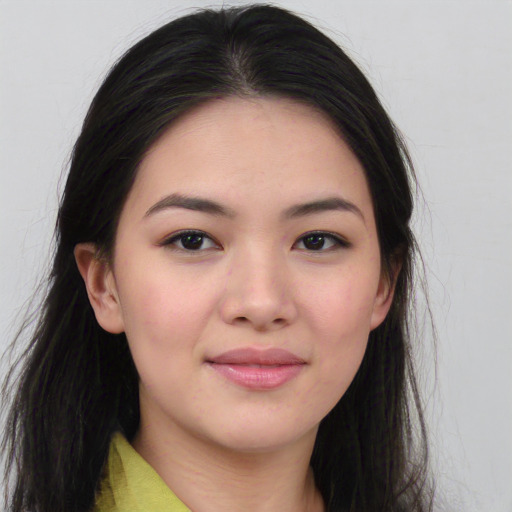 Joyful asian young-adult female with long  brown hair and brown eyes