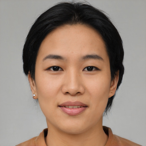 Joyful asian young-adult female with medium  black hair and brown eyes
