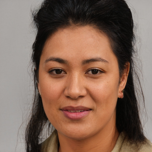 Joyful latino young-adult female with medium  brown hair and brown eyes