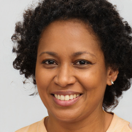 Joyful black young-adult female with medium  brown hair and brown eyes
