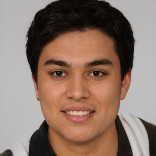 Joyful latino young-adult male with short  brown hair and brown eyes