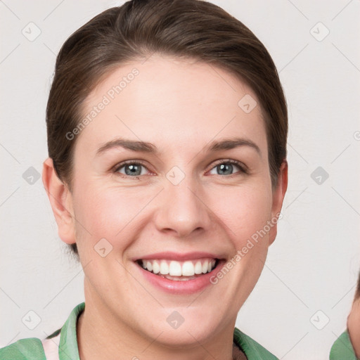 Joyful white young-adult female with short  brown hair and grey eyes