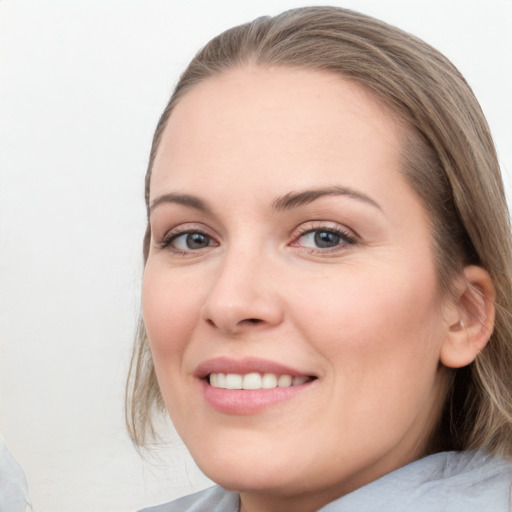 Joyful white young-adult female with medium  brown hair and blue eyes