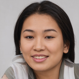 Joyful asian young-adult female with long  brown hair and brown eyes