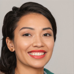 Joyful white young-adult female with long  black hair and brown eyes