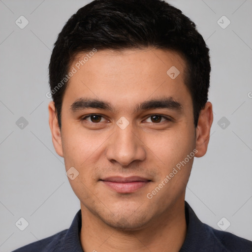 Joyful white young-adult male with short  black hair and brown eyes