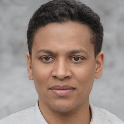 Joyful latino young-adult male with short  brown hair and brown eyes