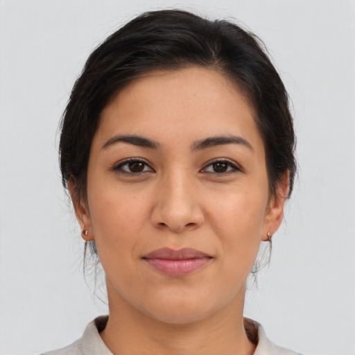 Joyful latino young-adult female with medium  brown hair and brown eyes