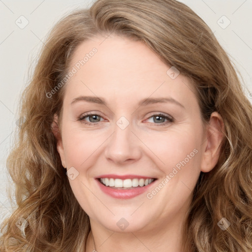 Joyful white young-adult female with long  brown hair and blue eyes