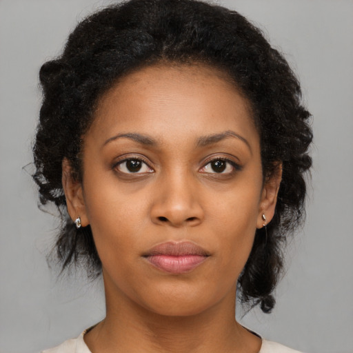 Neutral black young-adult female with medium  brown hair and brown eyes
