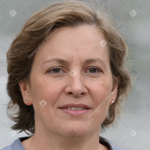 Joyful white adult female with medium  brown hair and grey eyes