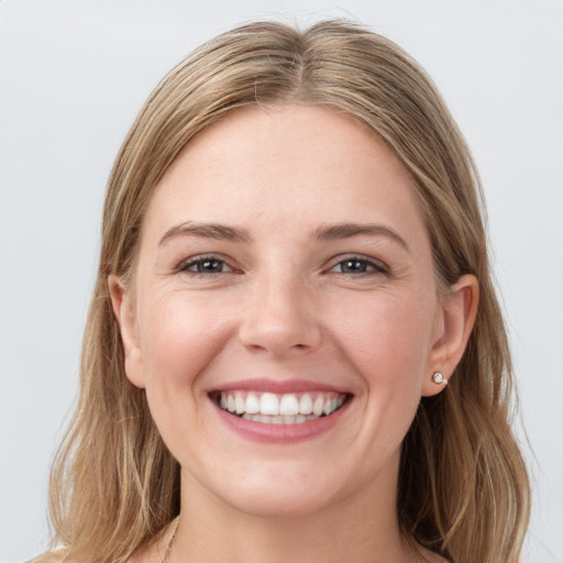 Joyful white young-adult female with long  brown hair and grey eyes