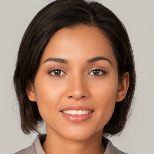 Joyful white young-adult female with medium  brown hair and brown eyes